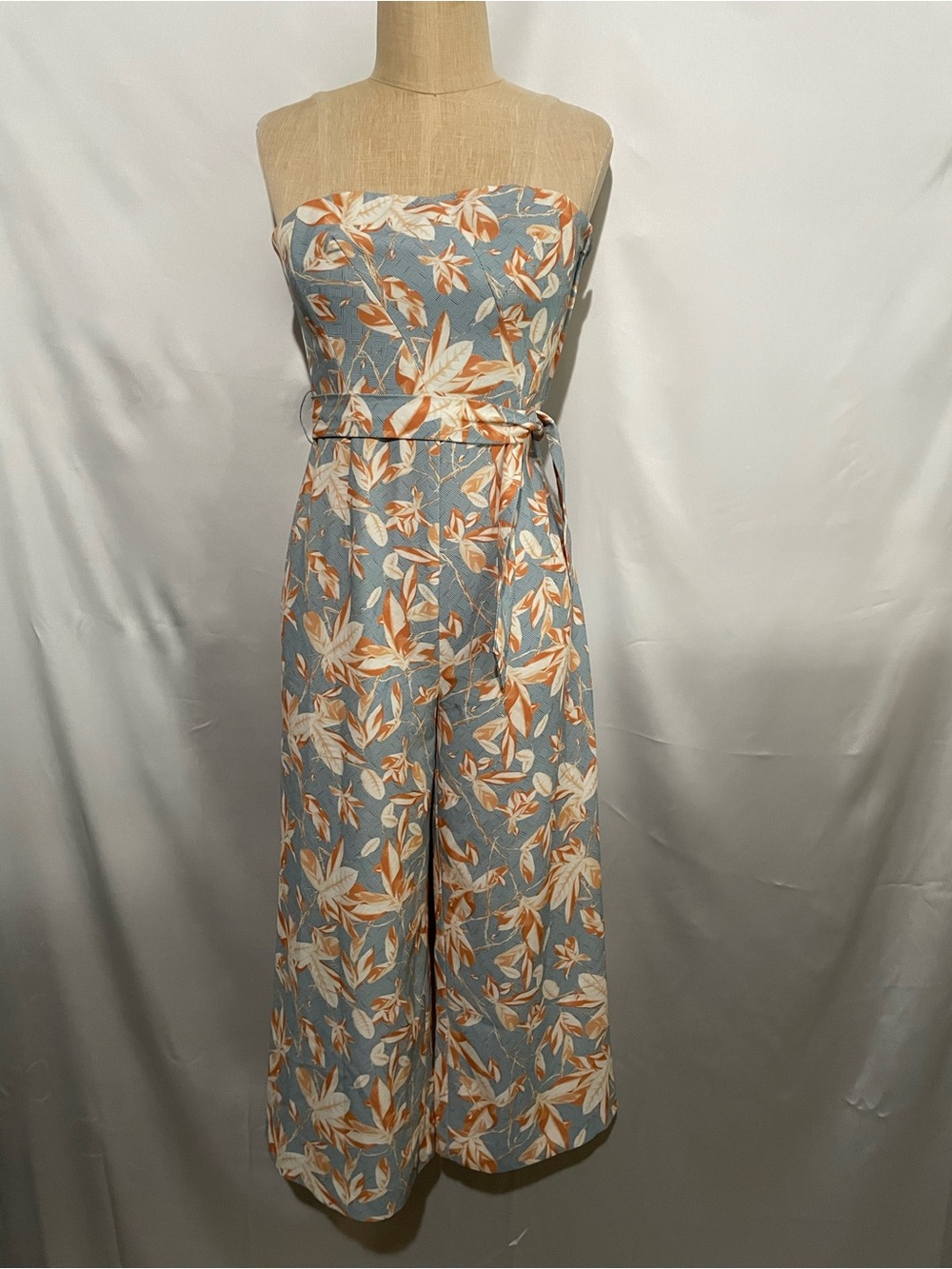 Strapless tropical print maxi romper with flowy resort-inspired silhouette